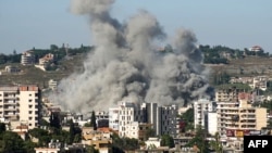 Smoke rises from the site of a string of Israeli air strikes that targeted the southern Lebanese city of Nabatieh on June 20.