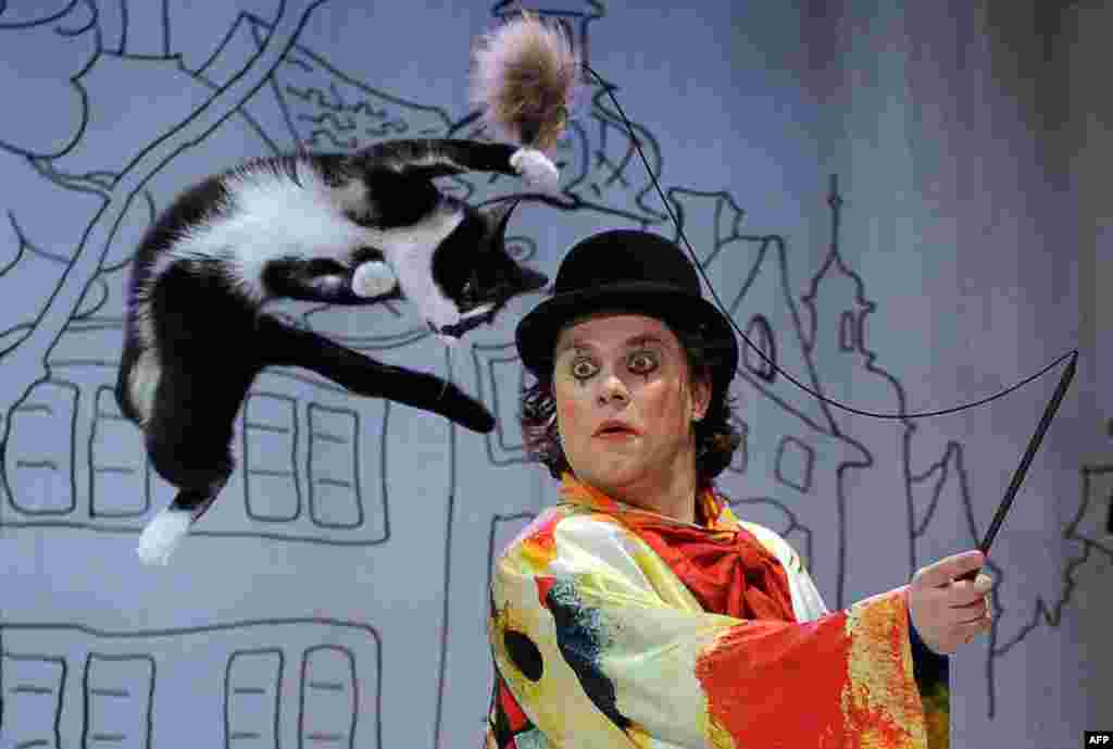 Vladimir Kouklatchev performs with a cat during a show in the Moscow Cat Theater, founded by his father, famous Russian clown Yury Kouklatchev, shortly before the fall of the Soviet Union. The theater was recently reopened after renovations. (AFP/Yury Kadobnov)