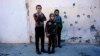 Boys watch as demining experts from the Iraqi Army search for booby-trapped buildings in eastern Mosul on January 17.