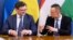 Ukrainian Foreign Minister Dmytro Kuleba (left) and his Hungarian counterpart, Peter Szijjarto, attend a signing ceremony in Budapest on May 29.
