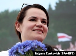 Presidential candidate Svyatlana Tsikhanouskaya smiles while holding a bouquet of flowers during a campaign rally in Minsk on July 19, 2020. Independent election monitors reported that she, in fact, won the August 9, 2020, vote. Instead, she was forced to flee to Lithuania.