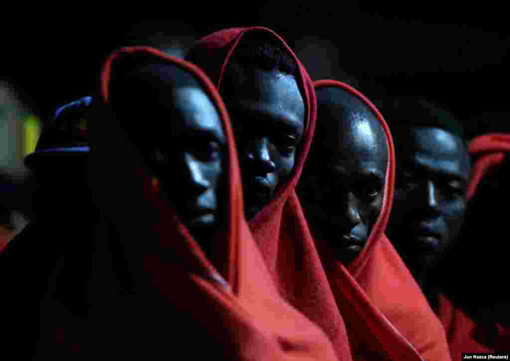 Migrants, intercepted off the coast in the Mediterranean Sea, wait to disembark from the Caliope rescue boat after arriving at the port of Malaga, southern Spain, on October 12. (Reuters/Jon Nazca)
