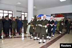 The coffin of the Russian pilot is carried out of a military hospital morgue by Turkish soldiers for its transfer to Esenboga Airport in Ankara on November 30.