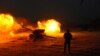 FILE: An Afghan National Army soldier fires an artillery shell during an ongoing anti-Taliban operation in Farah province in January.