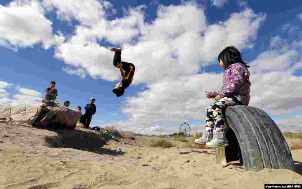 Children play at a park in Baikonur, Kazakhstan, near the Russian-leased cosmodrome. (EPA-EFE/Yury Kochetkov)