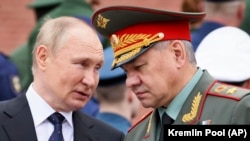 Russian President Vladimir Putin (left) said his decision for a partial military mobilization was made on the recommendation of Defense Minister Sergei Shoigu (right) and the General Staff. (file photo)