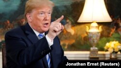 U.S. President Donald Trump speaks to reporters after signing a proclamation declaring his intention to withdraw from the JCPOA or Iran nuclear agreement in the Diplomatic Room at the White House in Washington, U.S. May 8, 2018. 