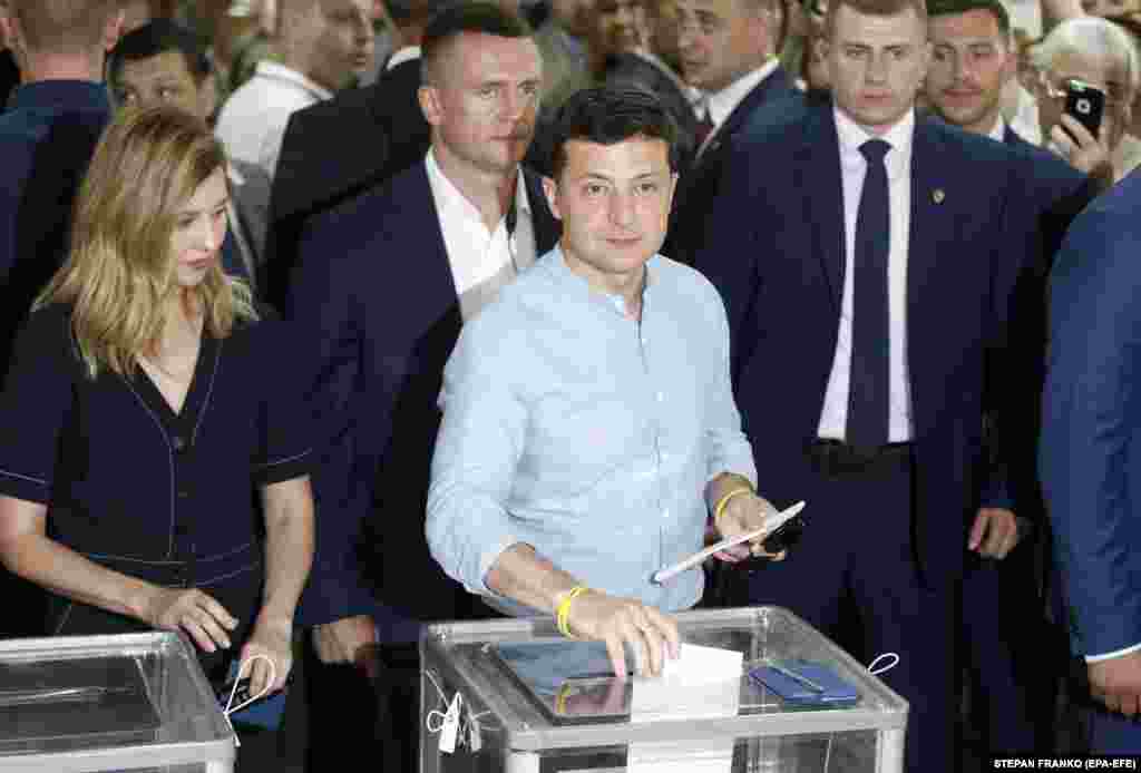 Ukrainian President Volodymyr Zelenskiy casts his ballot at a polling station in Kyiv. The 41-year-old former comedian portrayed Ukraine's president in a hit TV show. He faced a hostile parliament following his shock win in April's presidential election. He quickly called snap elections and has promised to bring in a new generation of politicians to lead the country. (EPA-EFE/Stepan Franko)