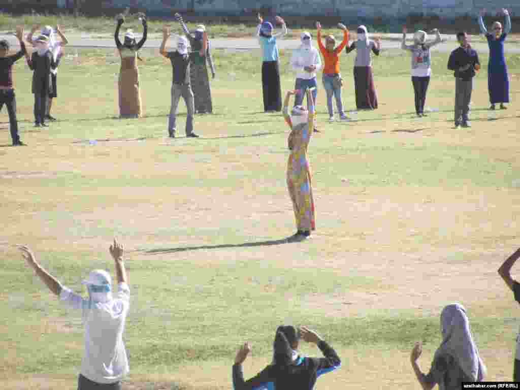 Training sessions take place under the watchful eyes of government-appointed instructors.