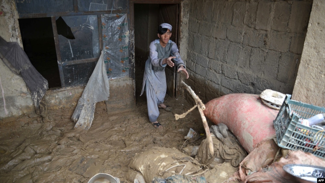 An Afghan man removes debris from his house following heavy rains and flash flooding in Kandahar on April 14.