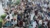 Supporters of the banned Islamist political party Tehrik-e Labaik Pakistan (TLP) protest in Lahore on October 23 demanding the release of their leader and the expulsion of the French ambassador over cartoons depicting the Prophet Muhammed.