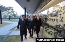 North Korean leader Kim Jong Un walks Russian State Duma speaker Vyacheslav Volodin (center) and Russian Defense Minister Andrei Beloussov past a display of drones at the Pyongyang memorial on April 26.
