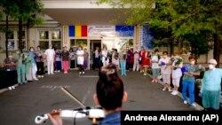 Personalul medical de la maternitatea Polizu din București ascultând un violinist