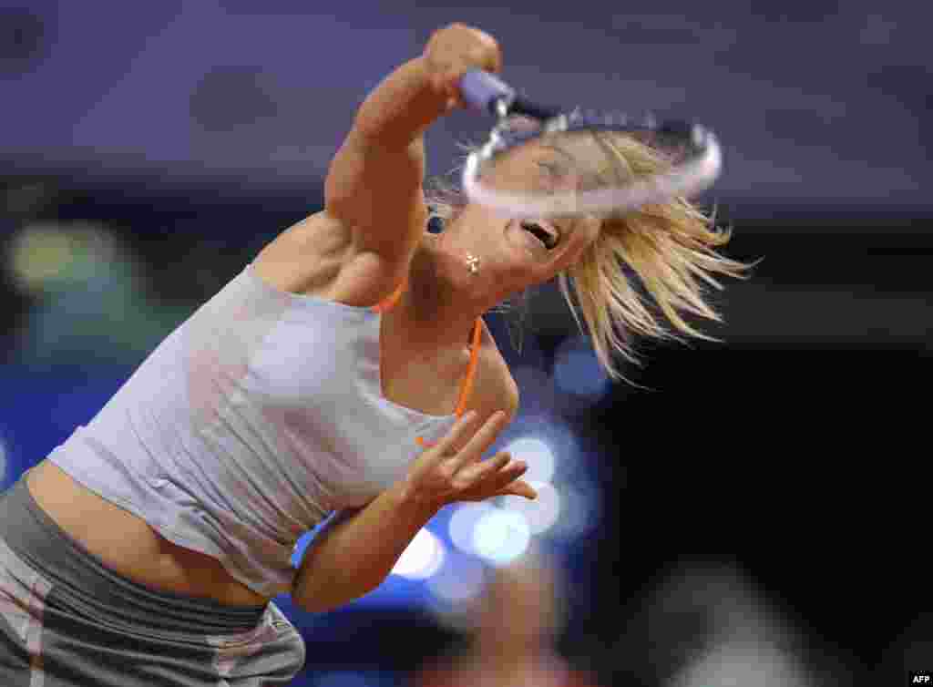 Russia&#39;s Maria Sharapova serves the ball to the Czech Republic&#39;s Lucie Safarova in their match at the WTA Porsche Tennis Grand Prix in Stuttgart, Germany. Sharapova won the match and later the tournament. (AFP/Thomas Kienzle) 