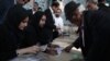 An elderly man registers to cast his ballot at a polling station in Tehran on May 19, 2017. 