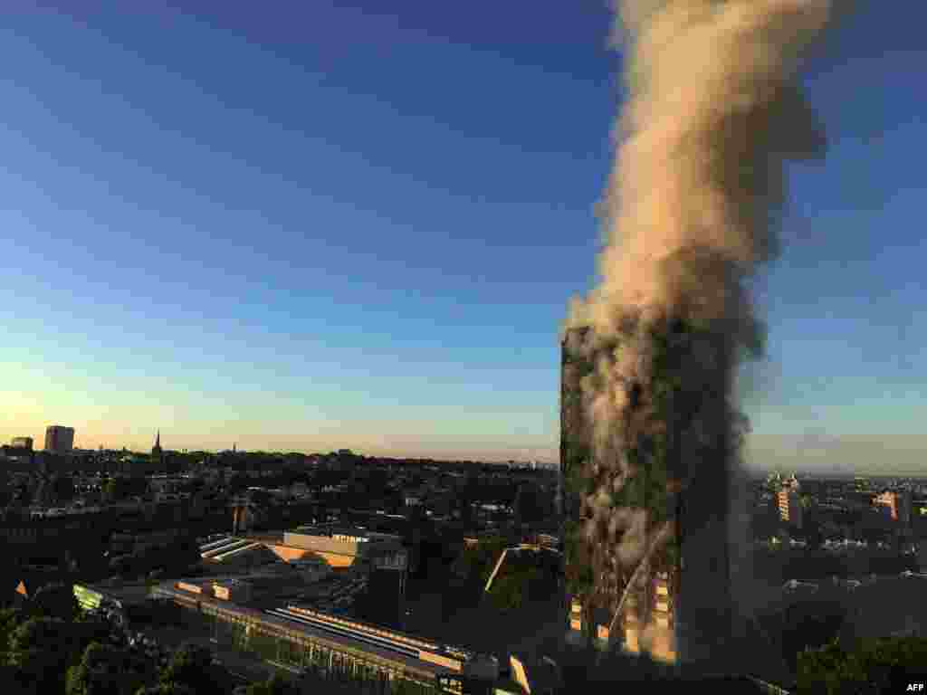 Smoke pours from a 27-story apartment building in west London on the morning of June 14. The fire brigade said 40 fire engines and 200 firefighters had been called to the blaze in Grenfell Tower, which has 120 flats. Officials say there have been a "number of fatalities." (AFP/Natalie Oxford)