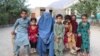 Orphans surround their grandmother Maryam. 