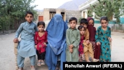 Orphans surround their grandmother Maryam. 