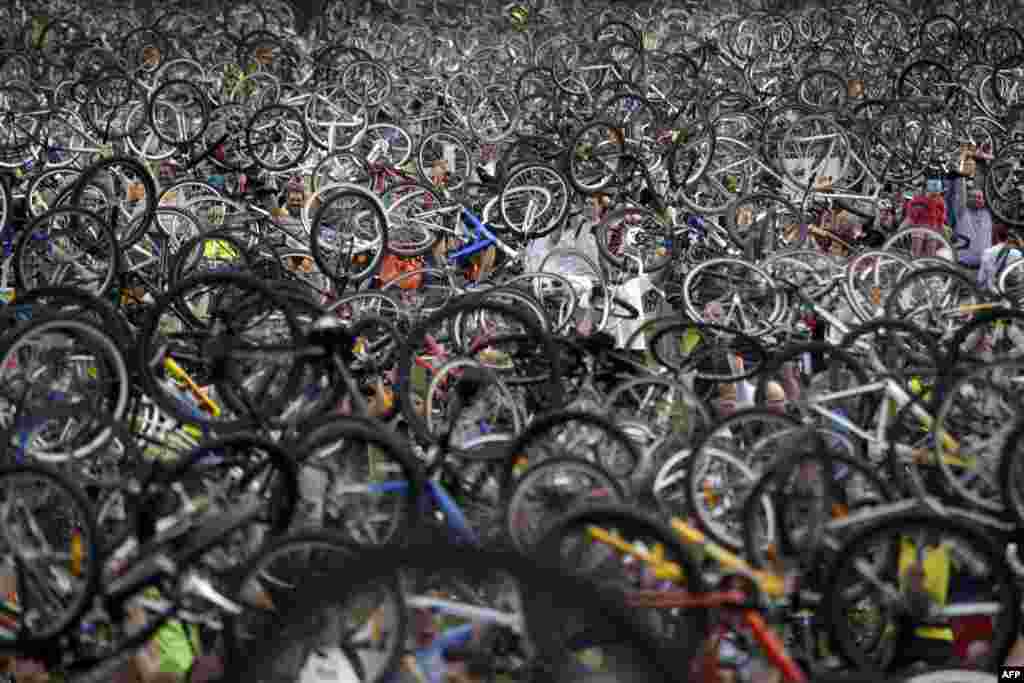 Hungarian cyclists raise their bikes in Budapest during a protest ride to promote cycling and to raise awareness about the need to improve cycling conditions in the city. (AFP/Ferenc Isza)
