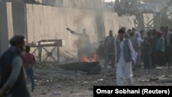 Angry Afghan protesters burn tires and shout slogans at the site of a Taliban attack in Kabul on September 3.