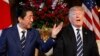 U.S. President Donald Trump and Japanese Prime Minister Shinzo Abe speak during a meeting at Trump's private Mar-a-Lago club, in Palm Beach, Florida, April 17, 2018