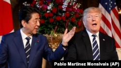 U.S. President Donald Trump and Japanese Prime Minister Shinzo Abe speak during a meeting at Trump's private Mar-a-Lago club, in Palm Beach, Florida, April 17, 2018