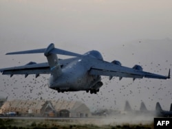 A U.S. Air Force heavy cargo plane takes off from Bagram air base, which sees frequent air traffic.