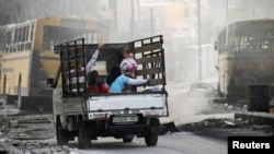Syria -- A family on a pick-up truck flees violence in the city of Aleppo, 17Oct2012