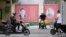 Portraits of Chinese President Xi Jinping (left) and the late Chinese leader Mao Zedong are seen on a street in Shanghai. Xi is poised to receive a third term as leader next month, something not done since Mao.
