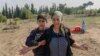 Aybeniz Khasanova, the mother of a 29-year-old soldier killed during fighting with Armenia, grieves next to his grave near the city of Agdam. Many other mothers are still awaiting word on the fates of their sons.