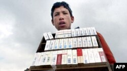 A young Afghan sells cigarettes in Kabul (file photo)