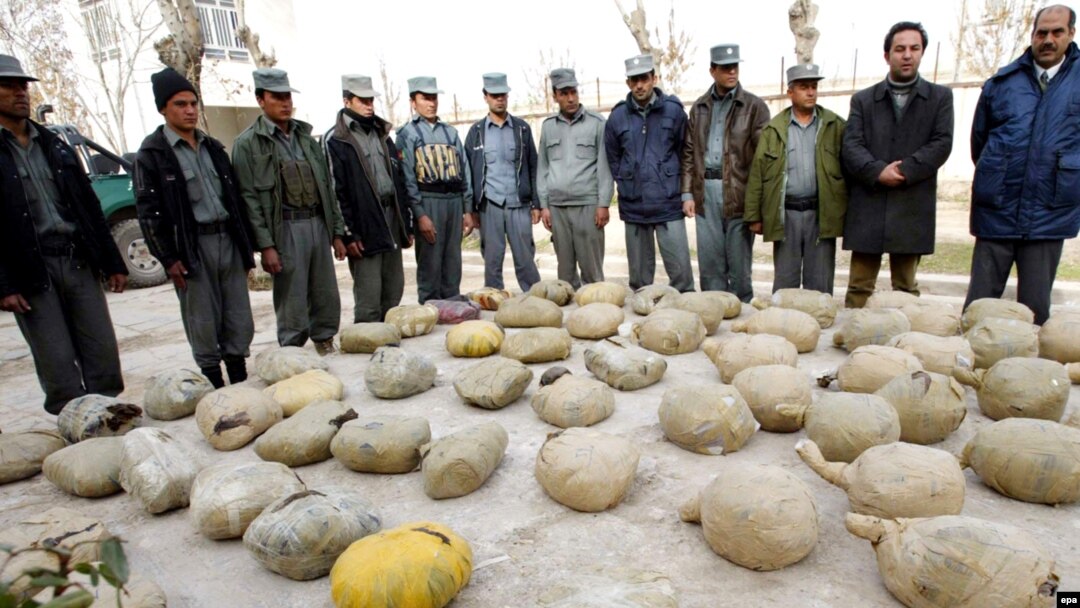 Police inspect piles of heroin discovered during an operation in Herat, Afghanistan