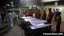 Staff of a local hospital in Karachi wait for casualties of bomb blast at a Sufi shrine in Shah Noorani, in Balochistan province near Karachi.