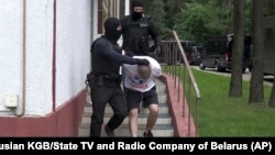 Belarusian KGB officers detain a Russian man in a sanitarium outside Minsk on July 29.