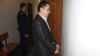Nurbek Qushaqbaev in handcuffs in a court in Astana on April 7.
