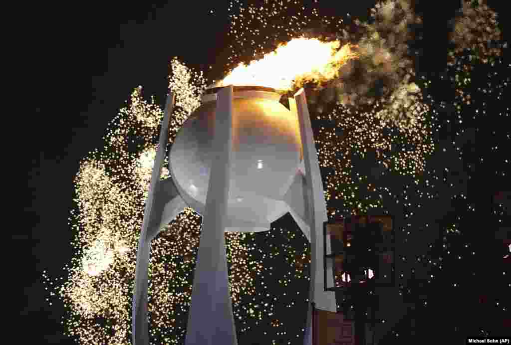 Fireworks explode over Olympic flame during the opening ceremony of the 2018 Winter Olympics in Pyeongchang.