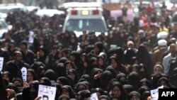 Antigovernment protesters attend the funeral of a comrade who died a day earlier from his wounds following clashes with police, in the town of Jidhafs on February 15.