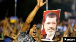 A member of the Muslim Brotherhood and supporter of ousted Egyptian President Muhammad Mursi shouts slogans outside a mosque in Cairo on July 4, one day after the ouster.