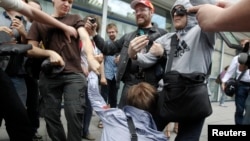 Russians attacking a gay-rights activist during a protest against the draft of the law against "gay propaganda" before the State Duma in early June.