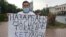 Kazakhstan - Erbolat Turkeev is holding a banner with the slogan against the authority. Almaty, 18 August 2020