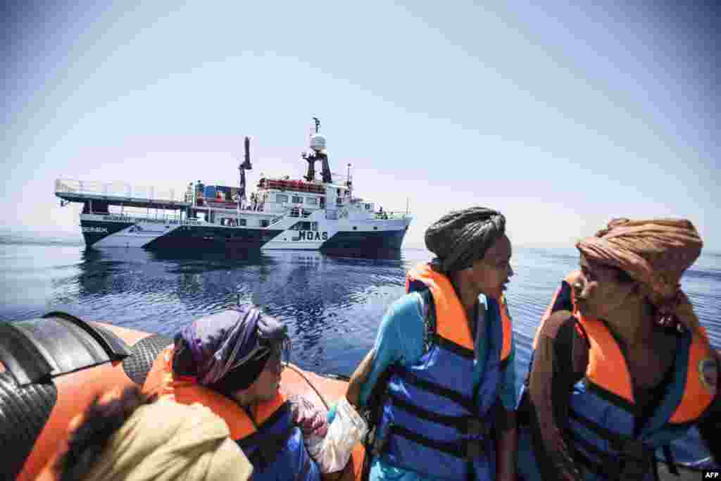 Women sit on a boat during a rescue operation for migrants off the coast of Sicily in the Mediterranean Sea, May 3. (AFP/MOAS/Jason Florio)