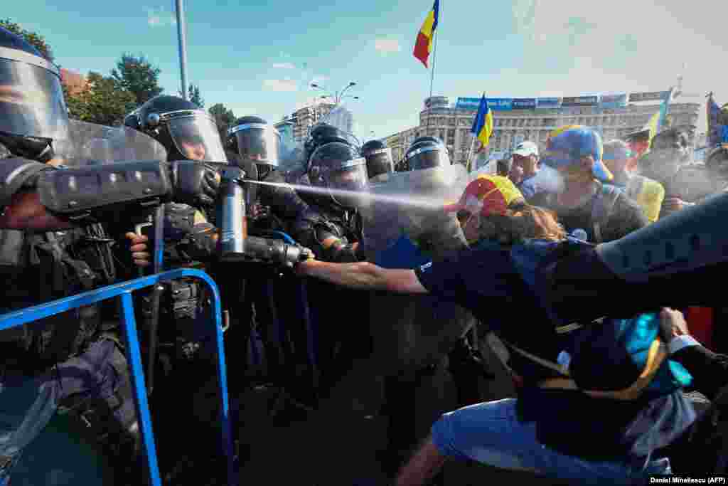 A jet of chemical spray catches a protester on August 10.&nbsp;