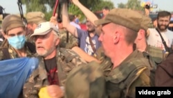 Members of an Orthodox Church procession scuffle with protesters as they approach Kyiv.