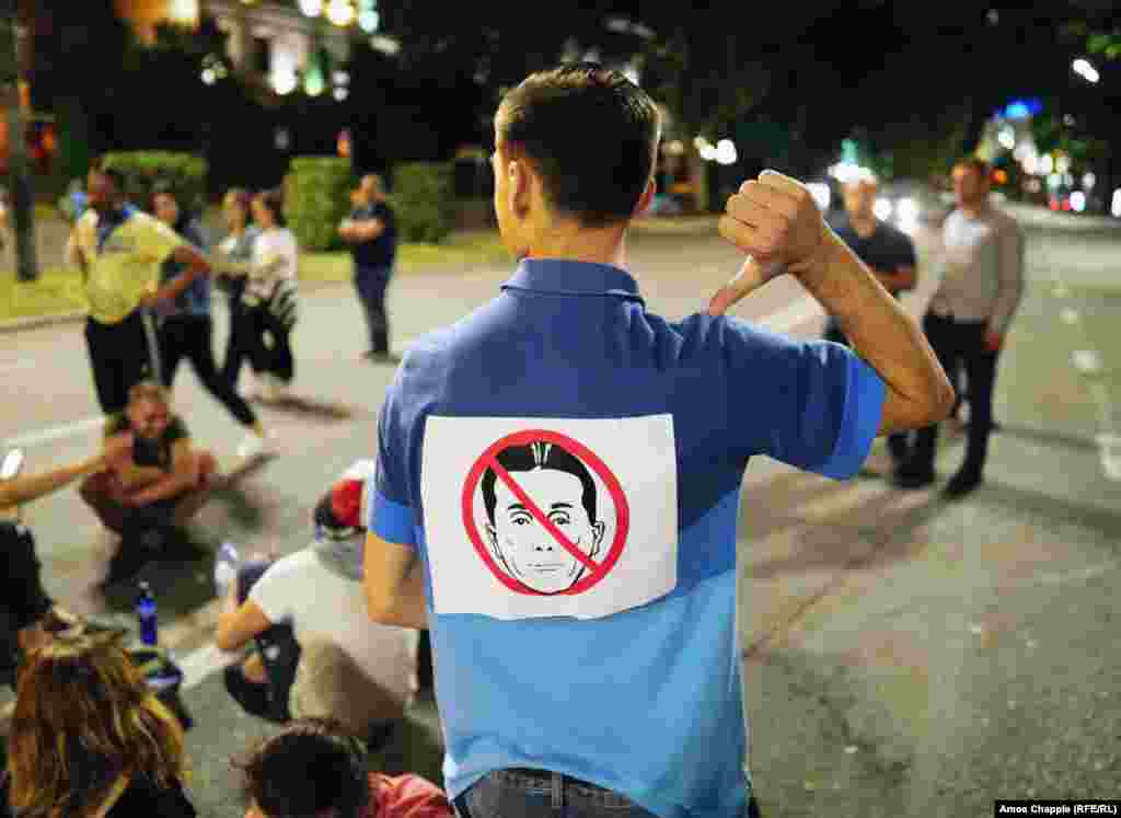 A protest sign directed at Georgian Dream leader Bidzina Ivanishvili. Protesters are demanding the resignation of high-level officials from his party, as well as punishment for law enforcement officials who used violence against the crowds. One of the protesters&#39; demands was met when Parliamentary Speaker Irakli Kobakhidze resigned on June 21.