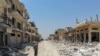 This file aerial view taken on August 3, 2019, shows a Syrian man inspecting the damages in the town of Khan Sheikhun in the southern countryside of the northwestern Idlib province.