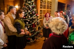 Ukrainian President Petro Poroshenko and his wife, Maryna, meet with Christmas singers in the Ivano-Frankivsk region of western Ukraine.