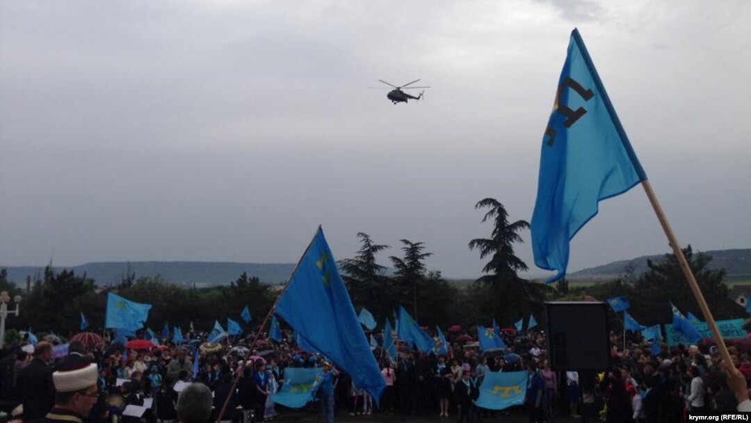 Helicopters circle overhead at a rally by Crimean Tatars in Bakhchyseray on May 18.