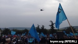Helicopters circle overhead at a rally by Crimean Tatars in Bakhchyseray on May 18.