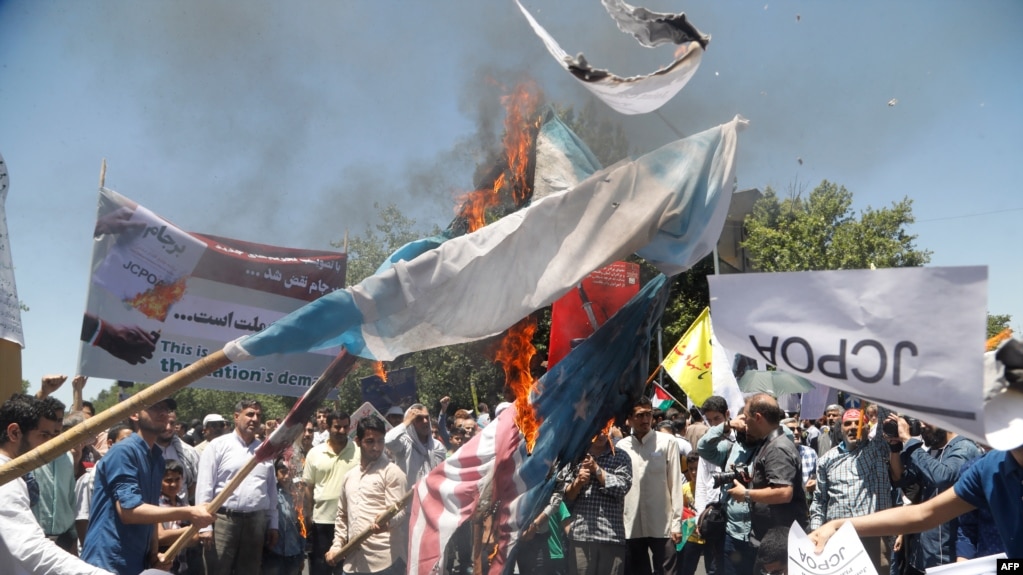 Iranians burn a U.S. flag during a rally marking Quds Day in Tehran on June 23.
