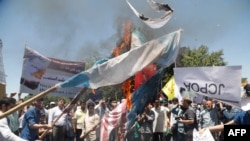 Iranians burn a U.S. flag during a rally marking Quds Day in Tehran on June 23.
